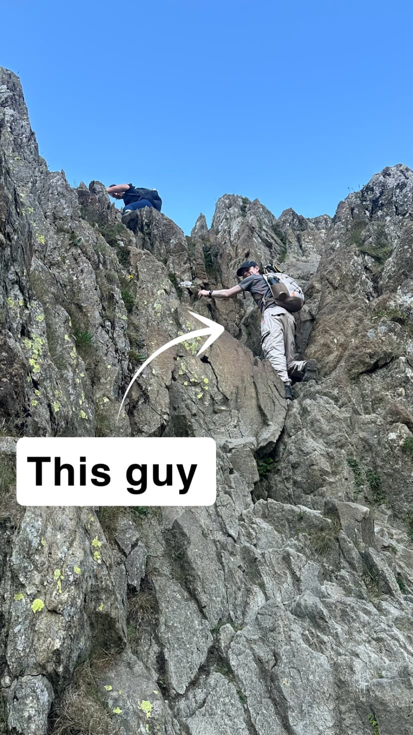 Chris, the OnTrack Cycling mechanic, scrambling on rock